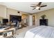 Spacious bedroom features a bed, ceiling fan, and desk with computer setup at 9378 Longstone Dr, Parker, CO 80134