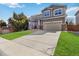 Inviting home with a well-manicured lawn and a spacious driveway leading to a two-car garage at 9378 Longstone Dr, Parker, CO 80134