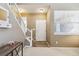 Bright and inviting foyer with a staircase, a front door, and neutral decor at 9378 Longstone Dr, Parker, CO 80134