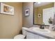 Cozy powder room featuring a vanity, mirror, and neutral decor at 9378 Longstone Dr, Parker, CO 80134