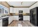 Functional kitchen with white cabinets, black appliances, and ample counter space at 9378 Longstone Dr, Parker, CO 80134