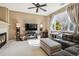 Comfortable living room featuring plush seating, modern fireplace, and lots of natural light at 9378 Longstone Dr, Parker, CO 80134