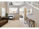 Spacious living room with fireplace, comfortable seating, and a soaring ceiling at 9378 Longstone Dr, Parker, CO 80134