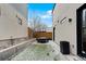 An enclosed backyard features minimalist landscaping, privacy fencing, and a modern patio at 1845 W 33Rd Ave, Denver, CO 80211