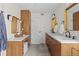 Modern bathroom featuring double vanity, white marble countertop and wood cabinets at 1845 W 33Rd Ave, Denver, CO 80211