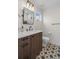 Stylish bathroom features a modern vanity with a white countertop and eye-catching patterned tile flooring at 1845 W 33Rd Ave, Denver, CO 80211