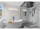 Bright bathroom with freestanding tub and walk-in shower with glass enclosure at 1845 W 33Rd Ave, Denver, CO 80211
