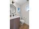 Well-appointed bathroom with a modern vanity, sleek fixtures, and a framed Jackson Hole ski resort print at 1845 W 33Rd Ave, Denver, CO 80211