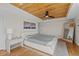 Modern bedroom featuring wood ceiling, sleek fan, and neutral decor at 1845 W 33Rd Ave, Denver, CO 80211