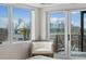 Bright bedroom with city views, chair, and sliding door to balcony at 1845 W 33Rd Ave, Denver, CO 80211