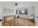 Bright bedroom featuring hardwood floors, console table, and large windows at 1845 W 33Rd Ave, Denver, CO 80211