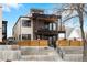 Modern home boasts a brick and stucco facade with a rooftop deck and a fenced front yard at 1845 W 33Rd Ave, Denver, CO 80211