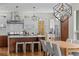 Modern kitchen with stainless steel appliances, wood cabinets, large island, and designer lighting at 1845 W 33Rd Ave, Denver, CO 80211