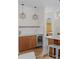 Close up view of a kitchen with an integrated wine fridge, custom cabinets, and designer lighting at 1845 W 33Rd Ave, Denver, CO 80211
