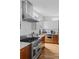 Close up view of a modern kitchen with stainless steel appliances, wood cabinets, and backsplash at 1845 W 33Rd Ave, Denver, CO 80211
