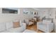 Spacious living room with a wet bar, light-colored furniture, hardwood floors, and abundant natural light at 1845 W 33Rd Ave, Denver, CO 80211