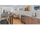 Bright living room boasts a wet bar, light wood floors, modern furnishings, and large windows with city views at 1845 W 33Rd Ave, Denver, CO 80211