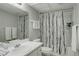 Full bathroom featuring a tub-shower combo with stylish curtain and a large mirror at 9995 E Harvard Ave # 155, Denver, CO 80231
