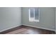This bedroom has hardwood floors and a large window for natural light at 9995 E Harvard Ave # 155, Denver, CO 80231