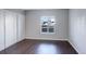 This bedroom has hardwood floors, a closet, and a large window for natural light at 9995 E Harvard Ave # 155, Denver, CO 80231