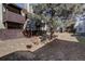Condo building's exterior with private patios and mature tree, set in a serene landscape that offers residents a unique experience at 9995 E Harvard Ave # 155, Denver, CO 80231