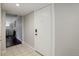 Inviting tiled entryway leads into a home with wood-look flooring, illuminated by modern lighting, with a coat closet at 9995 E Harvard Ave # 155, Denver, CO 80231