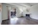 Bright living room featuring beamed ceiling, fireplace, and sliding glass doors to the patio at 9995 E Harvard Ave # 155, Denver, CO 80231