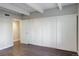 Main bedroom featuring a large closet with white sliding doors and hardwood flooring at 9995 E Harvard Ave # 155, Denver, CO 80231