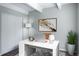 Virtual staging of an office with a light wood desk, chair, lamp, and plant at 9995 E Harvard Ave # 155, Denver, CO 80231