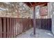 Private patio with wood railing, offering a cozy outdoor space surrounded by lush trees for relaxation and privacy at 9995 E Harvard Ave # 155, Denver, CO 80231