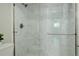 The shower has marble-style tiling and a glass door with a metal handle at 9995 E Harvard Ave # 155, Denver, CO 80231