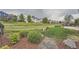Expansive backyard with a lush lawn, mature trees, and a charming wooden fence. Includes a concrete patio with seating at 5394 S Valdai Way, Aurora, CO 80015