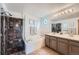 Elegant bathroom with dual sinks, a large soaking tub, and a separate shower at 5394 S Valdai Way, Aurora, CO 80015