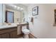 Well-lit bathroom featuring a single vanity, toilet, and neutral wall decor at 5394 S Valdai Way, Aurora, CO 80015