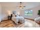 Bright bedroom with large window, ceiling fan, and light wood floors at 5394 S Valdai Way, Aurora, CO 80015