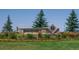 Saddle Rock Ridge community entrance sign with lush landscaping and clear blue skies at 5394 S Valdai Way, Aurora, CO 80015