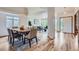 Inviting dining area featuring an elegant chandelier and hardwood floors, seamlessly connected to the living room at 5394 S Valdai Way, Aurora, CO 80015