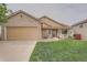 Charming single-Gathering home with a manicured lawn, covered porch, and brick accents on the garage and entrance at 5394 S Valdai Way, Aurora, CO 80015