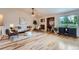 Bright and spacious living room with hardwood floors, a fireplace, and large windows offering natural light at 5394 S Valdai Way, Aurora, CO 80015