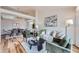 Open-concept living area with views of the dining room, featuring comfortable seating, modern decor, and hardwood floors at 5394 S Valdai Way, Aurora, CO 80015