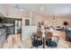 Open-concept living space with light wood floors, a modern kitchen, and a cozy seating area at 5394 S Valdai Way, Aurora, CO 80015