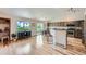 Bright living area with light wood floors, a modern kitchen, and access to the backyard at 5394 S Valdai Way, Aurora, CO 80015