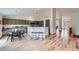 Spacious living area with light wood floors, a modern kitchen, and an open floor plan at 5394 S Valdai Way, Aurora, CO 80015