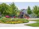 Colorful playground in a park setting surrounded by mature trees and landscaping at 5394 S Valdai Way, Aurora, CO 80015