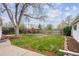 Expansive backyard showcasing a well-maintained lawn, a pergola, and a charming setting for outdoor enjoyment at 860 Zenobia St, Denver, CO 80204