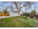Large backyard featuring a spacious lawn and a detached garage, providing ample outdoor space for activities at 860 Zenobia St, Denver, CO 80204