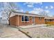 Charming brick home featuring a well-maintained lawn and a cozy front porch area at 860 Zenobia St, Denver, CO 80204