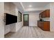 Finished basement with TV, wet bar, carpet, and access to the exterior at 27756 Troublesome Gulch Rd, Evergreen, CO 80439