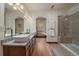 Bright bathroom featuring dual sinks, granite counters, and a glass-enclosed shower at 27756 Troublesome Gulch Rd, Evergreen, CO 80439