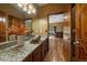 Bathroom with granite countertop, unique vessel sink, and wood-trimmed doorway to bedroom at 27756 Troublesome Gulch Rd, Evergreen, CO 80439